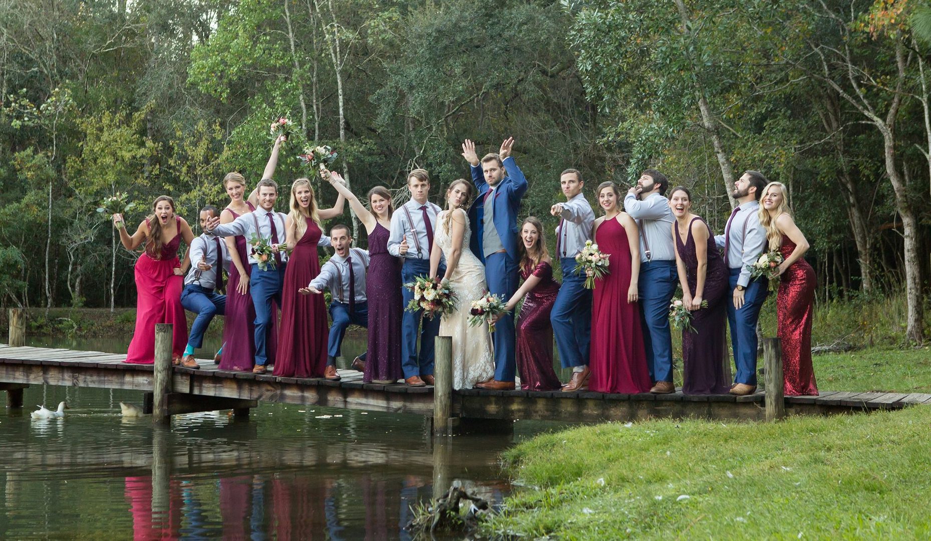 Wedding party on a dock by a lake.
